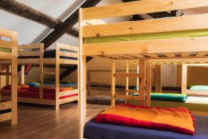 two bunk beds in a room with a room with at Refugio de Bujaruelo in Torla-Ordesa