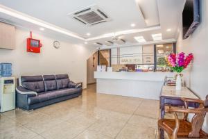 een woonkamer met een bank en een aanrecht bij Sam Hotel in Sitiawan
