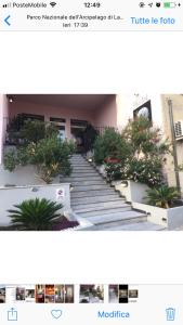 a picture of a staircase with plants in front of a building at Hotel La Conchiglia in La Maddalena