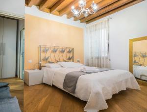 a bedroom with a large bed and a mirror at Appartamenti Venezia in Venice