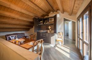 a kitchen and dining room with a wooden ceiling at Conte Federico Apartments in Palermo