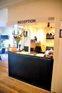 a reception counter in a store with a sign that reads reception at Hotel Abba in Amsterdam