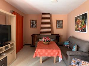 a living room with a table and a staircase at Apartamento Las Gacelas in Mazagón