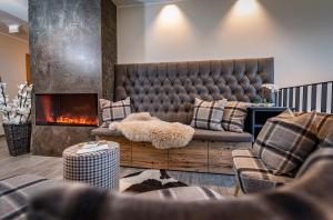 a living room with a couch and a fireplace at Skylodge Alpine Homes in Haus im Ennstal