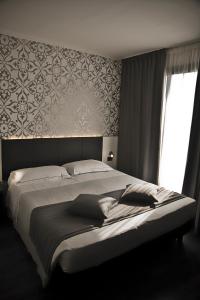 Posteľ alebo postele v izbe v ubytovaní Ilga Hotel