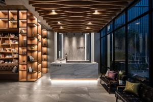 a lobby with a reception desk in a building at Tian Zhong Hotel in Tianzhong