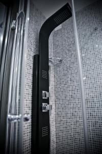 a shower with a mirror in a bathroom at Ilga Hotel in Collecchio