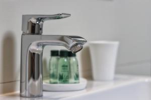 a bathroom sink with a faucet and a green toothpaste at Kseni Accommodation in Rovinj +57 photos