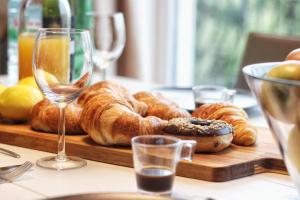a table with a tray of pastries and glasses of wine at Kseni Accommodation in Rovinj