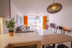 a living room with a couch and a table at Apartamento Atlántico Playa 2 in Puerto Naos +4 photos