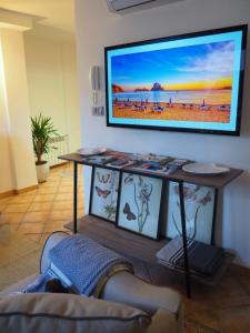 a living room with a flat screen tv on a wall at Häxaris Casa Boutique by Florentia Homes in Granada