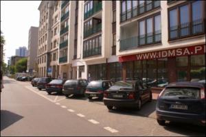 a row of cars parked on the side of a city street at P&O Serviced Apartments NOWOGRODZKA in Warsaw