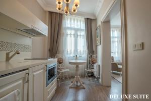 a kitchen with a table and chairs and a dining room at Louis Appartements Galata in Istanbul