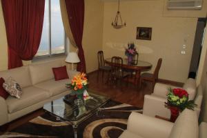 a living room with a couch and a table at Holiday Home Suites in Beirut