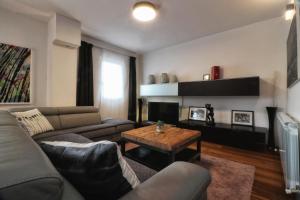 a living room with a couch and a coffee table at Kseni Accommodation in Rovinj