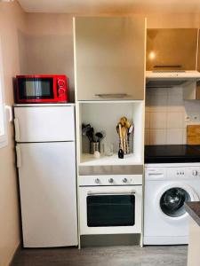 a kitchen with a white refrigerator and a microwave at Near DISNEYLAND. Your location to enjoy holidays. in Bussy-Saint-Georges