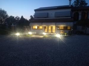 a house with lights in front of it at night at La Libellula in Villorba