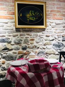 a table with a checkered table cloth on a brick wall at Old Bazaar Rooms in Korçë