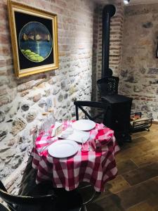 a table with a red and white checkered table cloth at Old Bazaar Rooms in Korçë