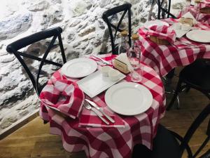 a table with a red and white checkered table cloth at Old Bazaar Rooms in Korçë