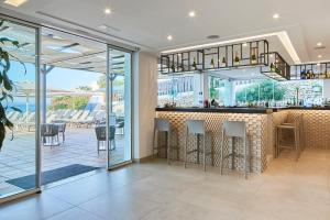 
a large kitchen with a large window at Sol Bahía Ibiza Suites in San Antonio
