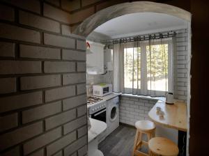 a kitchen with a brick wall and a stove top oven at KAYARAN home in Gyumri