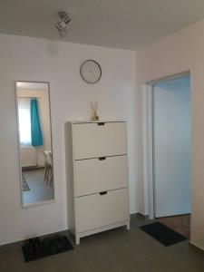 a white dresser in a room with a mirror at Cosy Home at 100 m from Iulius Town in Timişoara