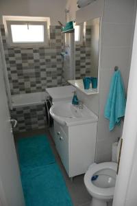 a bathroom with a white sink and a toilet at Cosy Home at 100 m from Iulius Town in Timişoara