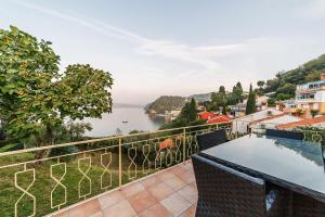 a balcony with a view of a body of water at Guest house - počitniška hiška v Fiesi, Piran in Piran