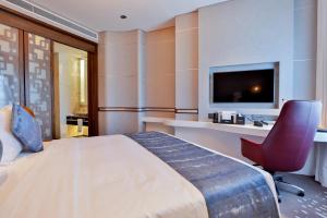 Un pat sau paturi într-o cameră la VIP Hotel Doha Qatar