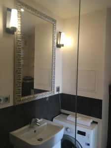 a bathroom with a sink and a mirror at Apartament Neptun in Jastrzębia Góra