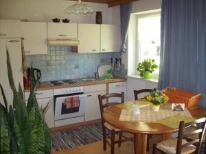 a kitchen with a table and a table and a dining room at Apartmenthaus Simmer in Obertraun