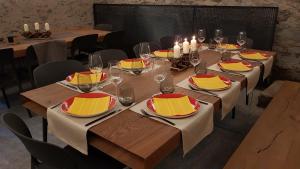 a dining room with tables with chairs and candles at BnB Ai Cav Calanca in Arvigo