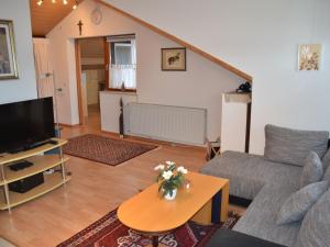 a living room with a couch and a tv at Ferienwohnung Thelen in Wallbach