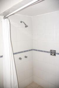 a bathroom with a shower with a shower curtain at Hotel Roma in Durango