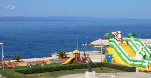 a water park with a playground with a slide at Apartments Lena in Podgora