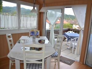 a white table and chairs in a room with a balcony at Ferienwohnung Thelen in Wallbach