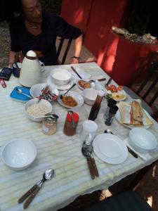 a woman sitting at a table with plates of food at Bendula in Tujering