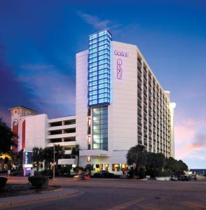 a hotel building with a sign on the side of it at Hotel Blue in Myrtle Beach