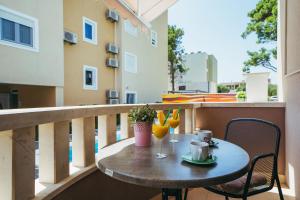 a table on a balcony with two glasses of orange juice at Villa Promajna 5 in Promajna