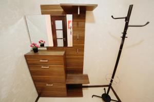a stairwell with a mirror and a dresser with a dresser at Apartment on Lenin Avenue in Gomel