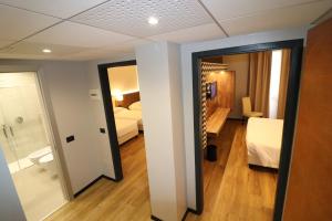 Ένα ή περισσότερα κρεβάτια σε δωμάτιο στο Hotel Domenichino