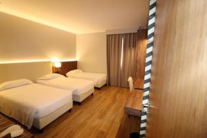 Ένα ή περισσότερα κρεβάτια σε δωμάτιο στο Hotel Domenichino