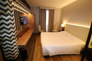Ένα ή περισσότερα κρεβάτια σε δωμάτιο στο Hotel Domenichino