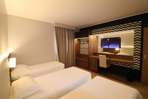 Säng eller sängar i ett rum på Hotel Domenichino