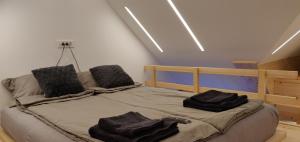 a bedroom with a bed with towels on it at Vila Mojca - Studio 13 in Kranjska Gora