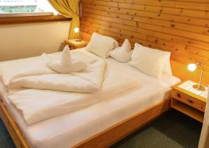 Postel nebo postele na pokoji v ubytování Garni - Hotel Rinner Julia