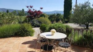 a white table and chairs on a patio at La Parenthèse in Lauris