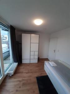 an empty room with a large window and a door at Sophies Apartment in Stuttgart