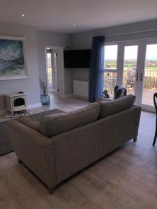a living room with a couch and a television at Portview in Portrush